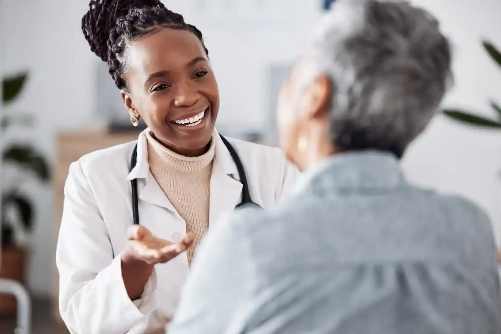black female doctor smiling and laughing with patient
